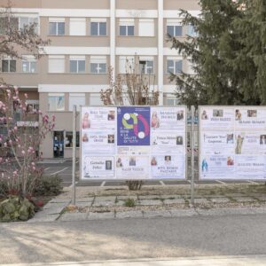 CAILUNGO, SAN MARINO - MARCH 27: The vaccination campaign poster inserted in the middle of the photos of the dead people in front of the State Hospital of Cailungo, San Marino on March 27, 2021. (Photo by Davide Bertuccio for The Washington Post)